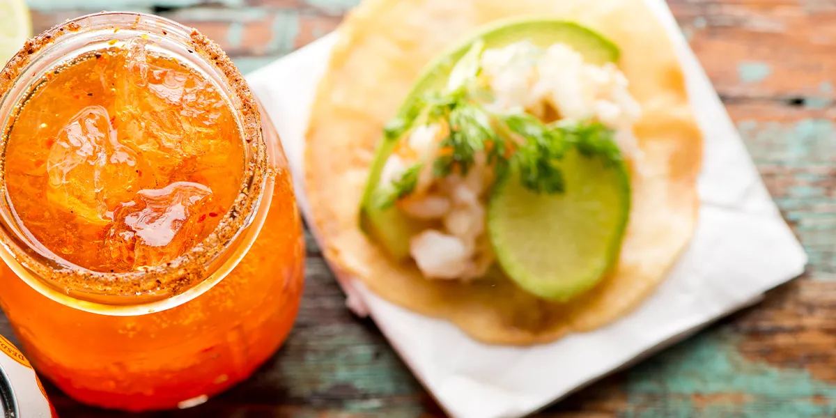 Spicy iced cocktail paired with a fresh lime and prawn taco, part of Bargain Booze’s Flavour Fest Drinks Deals food pairing ideas.