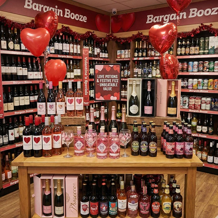 Valentine’s themed Bargain Booze in store display with wines, pink gin and sparkling bottles, perfect for Cosy Nights In: Comfort Drinks Done Properly